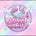 A digital graphic logo for 'Sweet Vanity' featuring a circular mirror with pink hearts, a handbag, and lipstick, set against a pastel pink and iridescent rainbow background with sparkles.